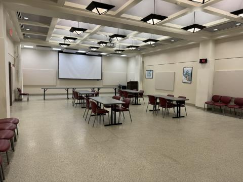 Large room with terrazzo floor, projection screen, and ample seating