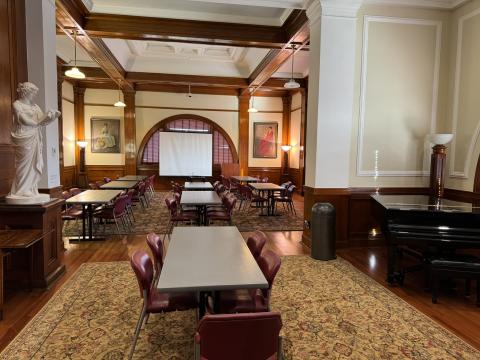 Image of room with baby grand piano on the right side, with white marble statue on the left.